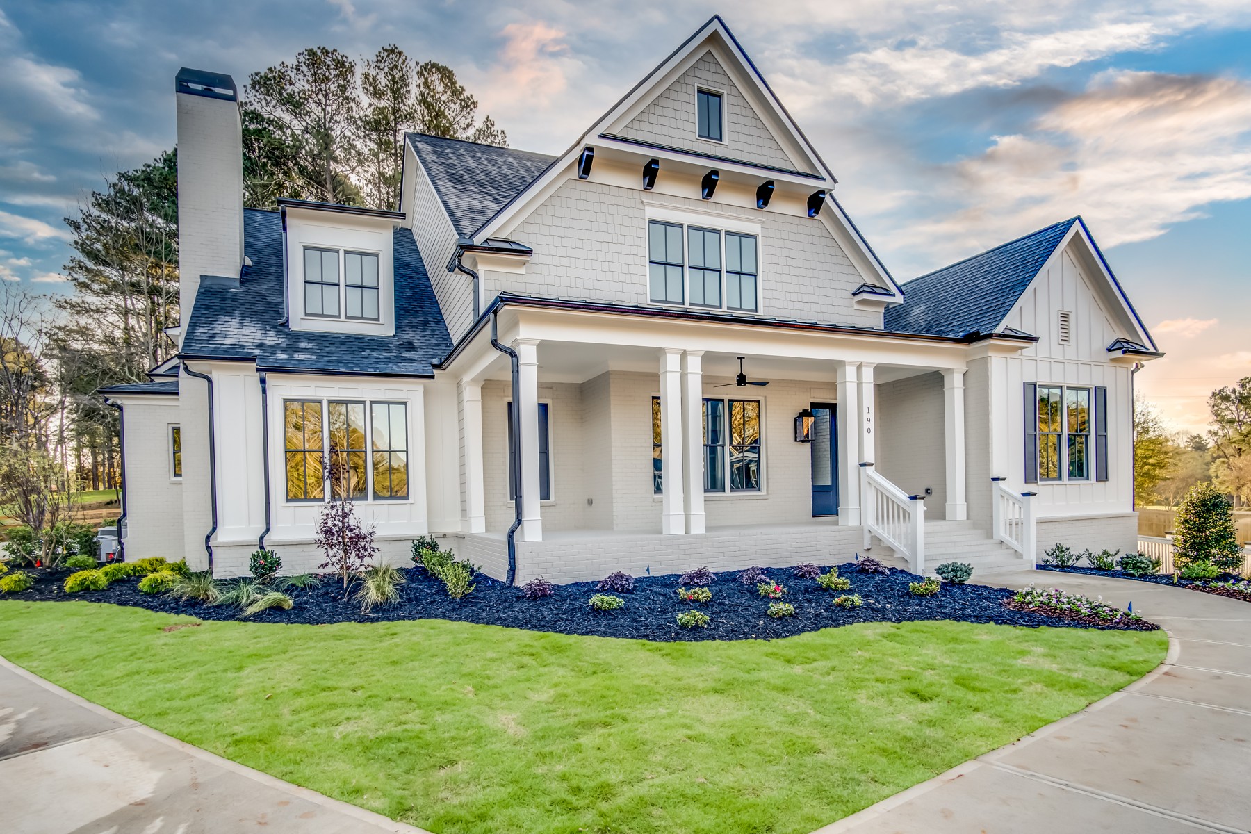 White custom home with a welcoming front porch