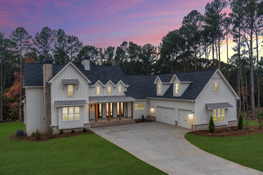 Custom home at dusk beneath a pink sky