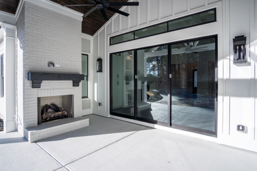 Covered outdoor living space with a fireplace