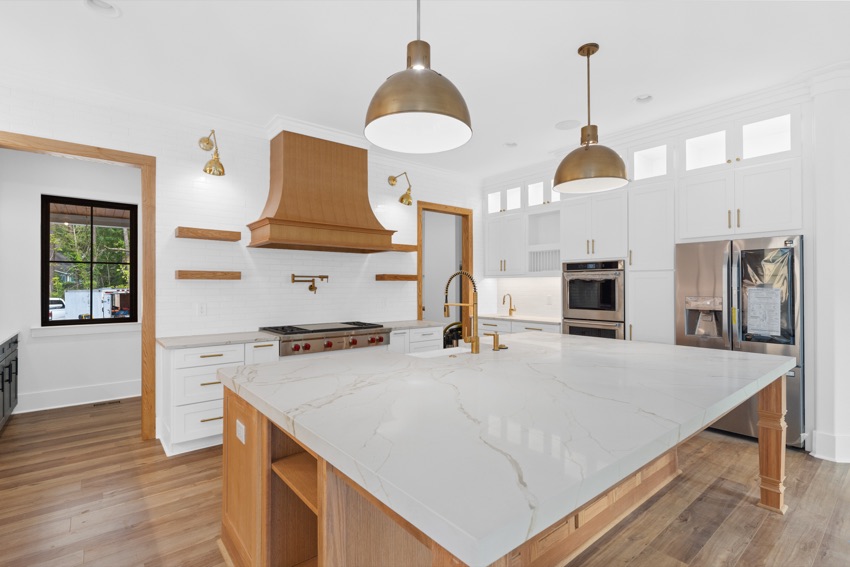 Bright kitchen with oak cabinetry and a marble island